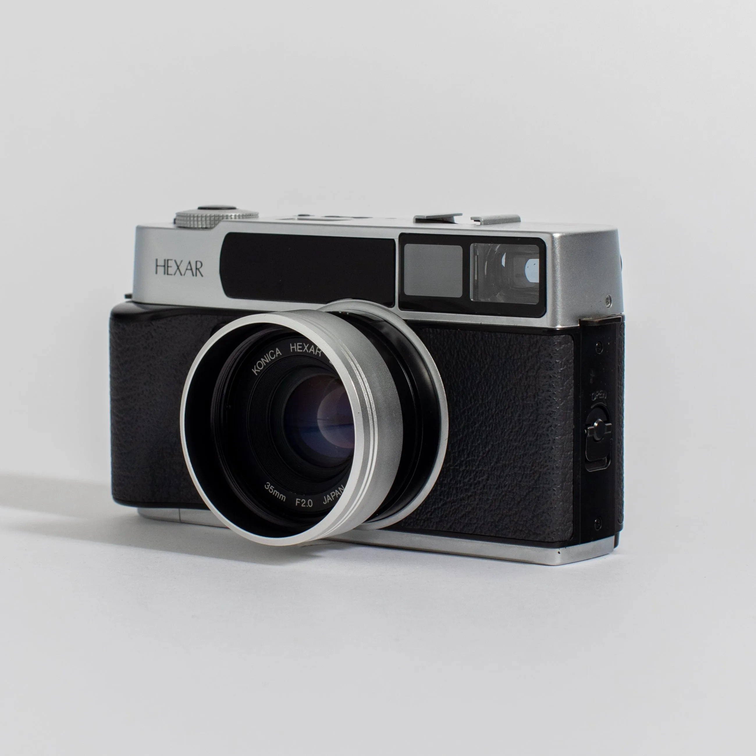 Konica Hexar Silver with 35mm f2 lens, leather case, and strap